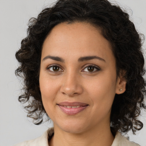 Joyful latino young-adult female with medium  brown hair and brown eyes