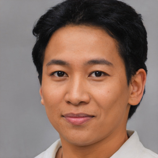 Joyful asian young-adult male with short  black hair and brown eyes
