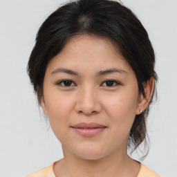 Joyful asian young-adult female with medium  brown hair and brown eyes