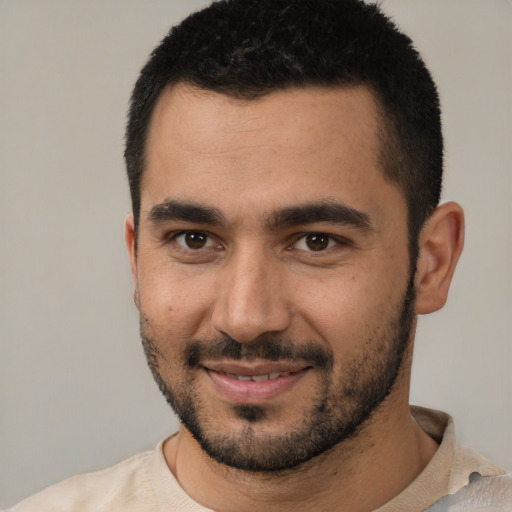 Joyful white young-adult male with short  black hair and brown eyes