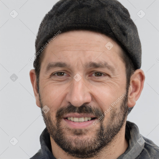 Joyful white adult male with short  black hair and brown eyes