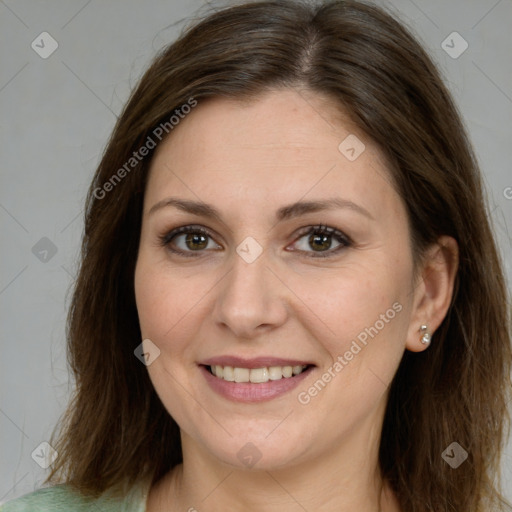 Joyful white adult female with long  brown hair and brown eyes