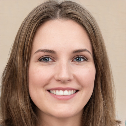 Joyful white young-adult female with long  brown hair and green eyes