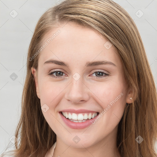 Joyful white young-adult female with long  brown hair and blue eyes