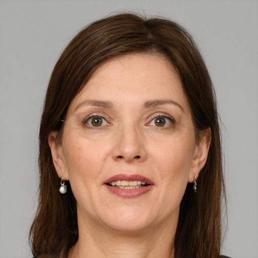 Joyful white adult female with medium  brown hair and grey eyes