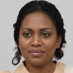 Joyful black adult female with medium  brown hair and brown eyes