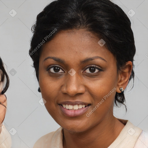 Joyful black young-adult female with medium  brown hair and brown eyes