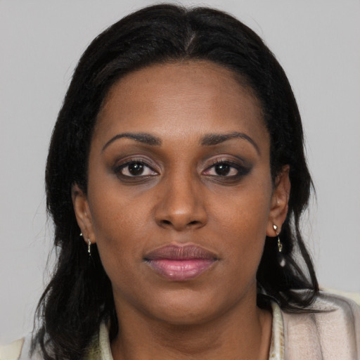 Neutral black young-adult female with long  brown hair and brown eyes