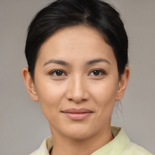 Joyful asian young-adult female with short  brown hair and brown eyes