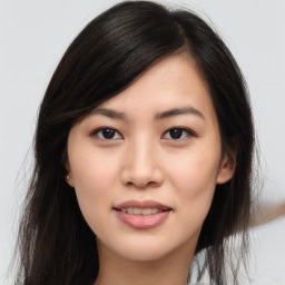 Joyful asian young-adult female with long  brown hair and brown eyes