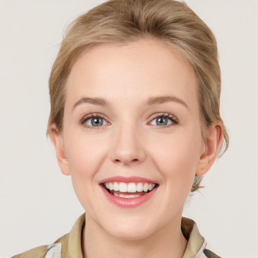 Joyful white young-adult female with medium  brown hair and green eyes