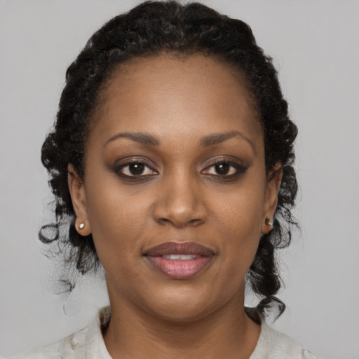Joyful black adult female with medium  black hair and brown eyes