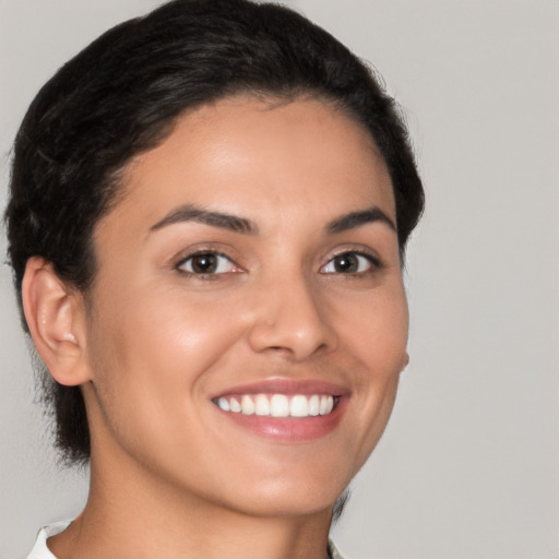 Joyful latino young-adult female with short  brown hair and brown eyes