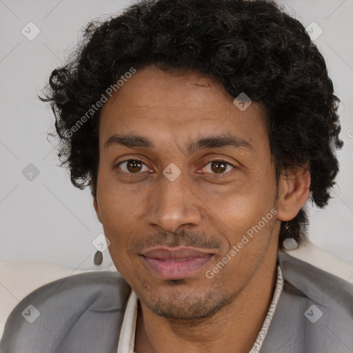 Joyful black adult male with short  black hair and brown eyes