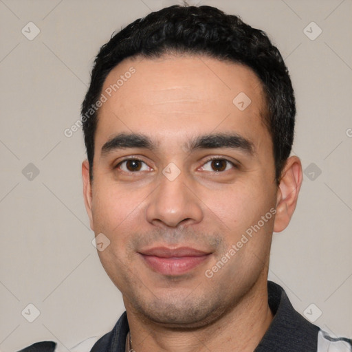 Joyful white young-adult male with short  black hair and brown eyes