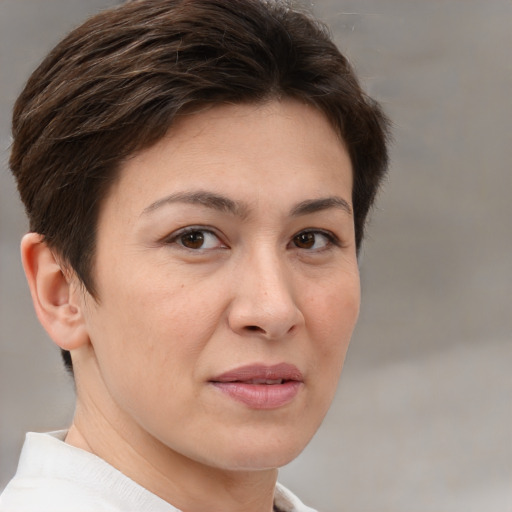 Joyful white adult female with short  brown hair and brown eyes