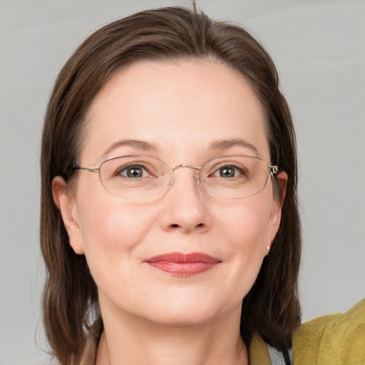 Joyful white adult female with medium  brown hair and grey eyes