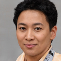 Joyful latino young-adult male with short  brown hair and brown eyes