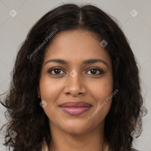 Joyful black young-adult female with long  brown hair and brown eyes