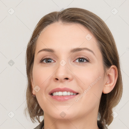 Joyful white young-adult female with medium  brown hair and grey eyes