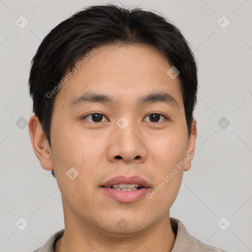 Joyful asian young-adult male with short  brown hair and brown eyes