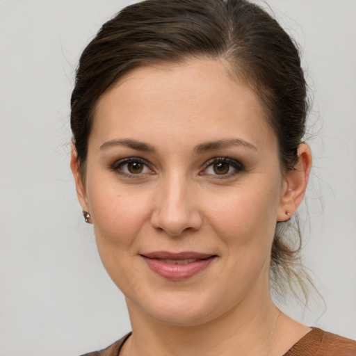 Joyful white young-adult female with medium  brown hair and brown eyes