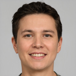 Joyful white young-adult male with short  brown hair and brown eyes