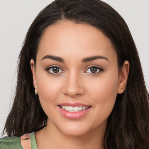 Joyful white young-adult female with long  brown hair and brown eyes