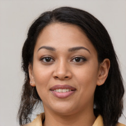 Joyful latino young-adult female with medium  brown hair and brown eyes