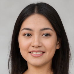 Joyful asian young-adult female with long  brown hair and brown eyes