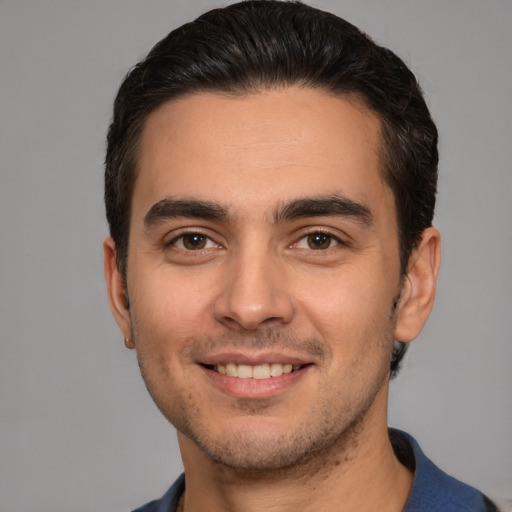 Joyful white young-adult male with short  brown hair and brown eyes