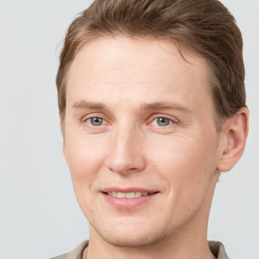 Joyful white adult male with short  brown hair and grey eyes