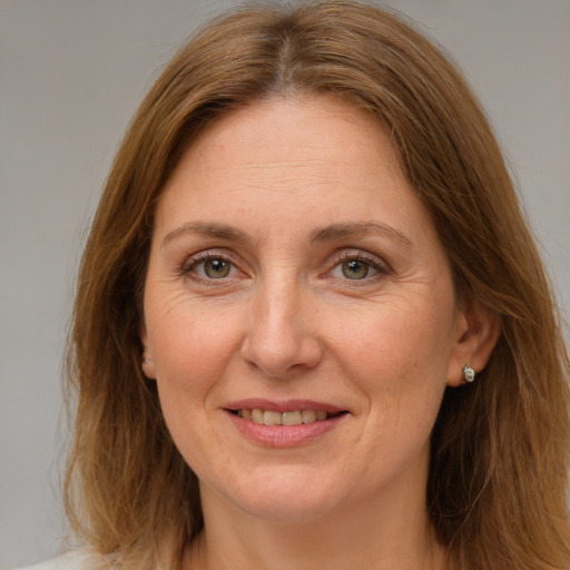 Joyful white adult female with medium  brown hair and brown eyes