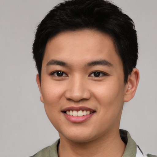 Joyful asian young-adult male with short  black hair and brown eyes