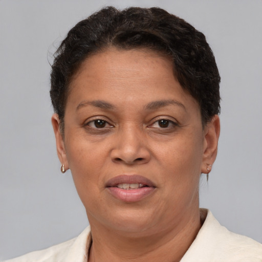 Joyful latino adult female with short  brown hair and brown eyes