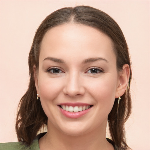 Joyful white young-adult female with long  brown hair and brown eyes