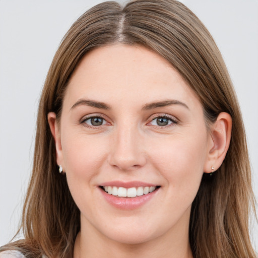 Joyful white young-adult female with long  brown hair and grey eyes