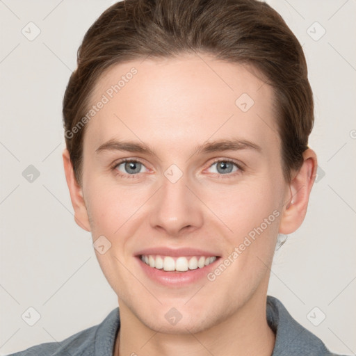 Joyful white young-adult female with short  brown hair and grey eyes