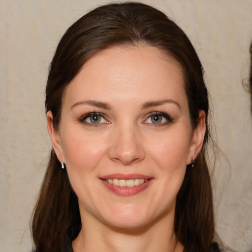 Joyful white young-adult female with long  brown hair and brown eyes