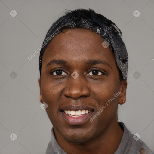 Joyful black young-adult male with short  black hair and brown eyes