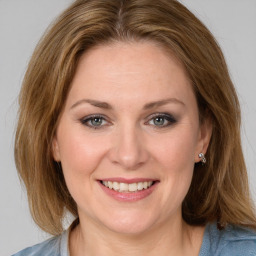 Joyful white young-adult female with medium  brown hair and blue eyes