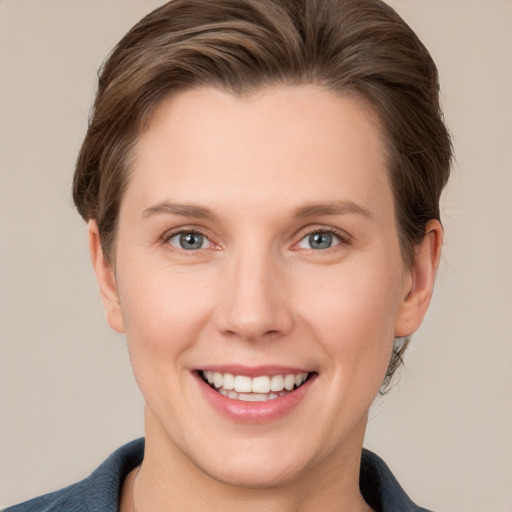 Joyful white young-adult female with short  brown hair and grey eyes