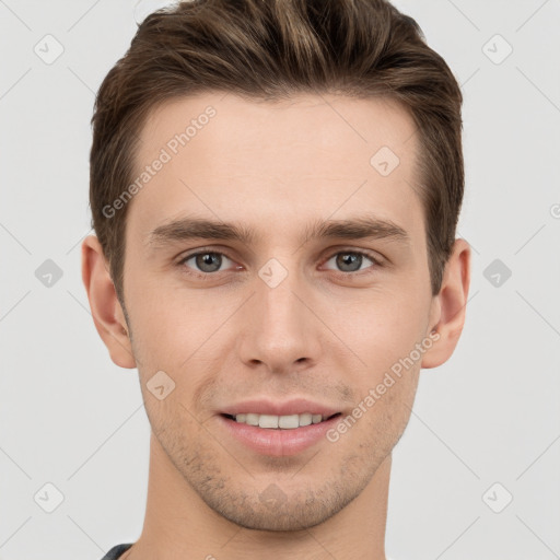 Joyful white young-adult male with short  brown hair and grey eyes