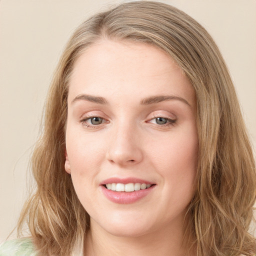 Joyful white young-adult female with long  brown hair and green eyes