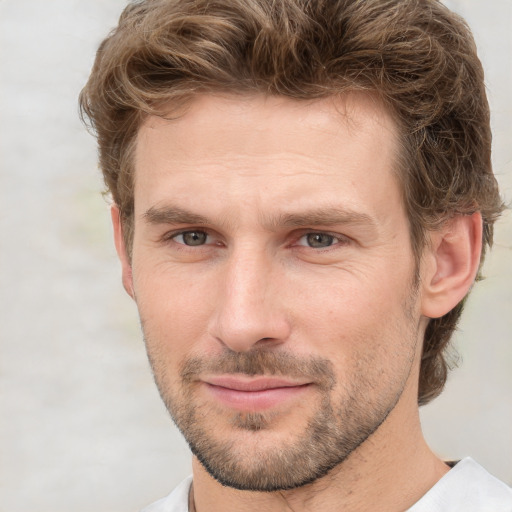 Joyful white adult male with short  brown hair and grey eyes