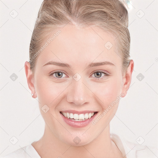 Joyful white young-adult female with short  brown hair and blue eyes