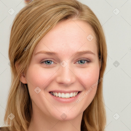 Joyful white young-adult female with long  brown hair and blue eyes