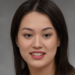 Joyful asian young-adult female with long  brown hair and brown eyes