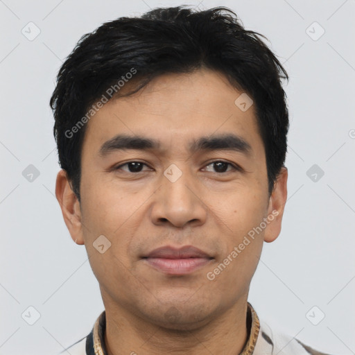 Joyful asian young-adult male with short  black hair and brown eyes