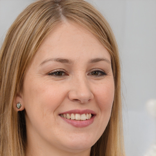 Joyful white young-adult female with long  brown hair and brown eyes